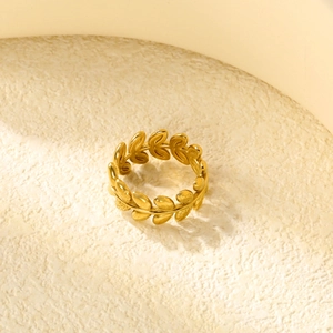 Macro shot of gold olive leaf ring with detailed texture and 18K gold polished finish