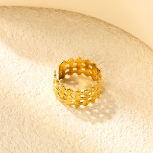 Close-up of golden adjustable open ring featuring unique hollow woven texture design