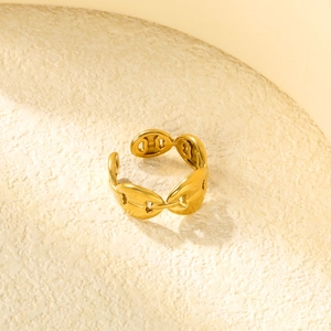 Detailed close-up of golden adjustable ring with stylish pig nose link design