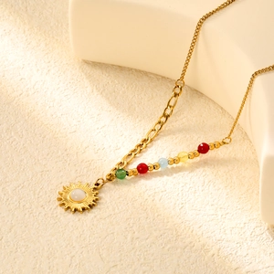 Detail of sun pendant necklace with natural stone and colorful beads on gold chain