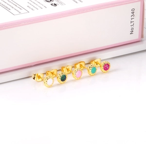 Close-up of glitter-filled circular earrings in colorful resin with 18K gold plated trim