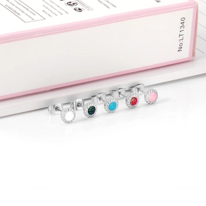 Detail of round glitter studs in five colors with twisted rope texture and 18K gold plating