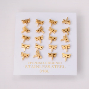 Macro shot of 12 pairs of golden dragonfly studs on 316L hypoallergenic stainless steel card
