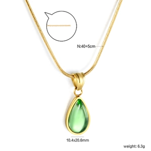 Detail of gold sun necklace with green natural stone and dimensions measurement