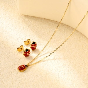 Golden ladybug jewelry set with red enamel studs and matching pendant necklace
