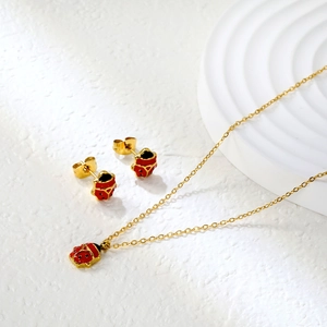 Golden ladybug jewelry set featuring a necklace and stud earrings with red enamel