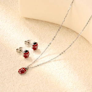 Stainless steel ladybug jewelry set with red enamel necklace and matching stud earrings