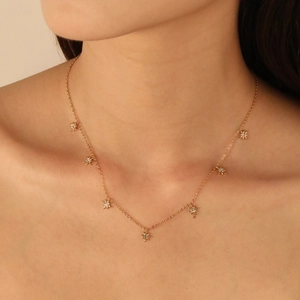 Elegant gold-tone star pendant necklace with cubic zirconia on a delicate link chain