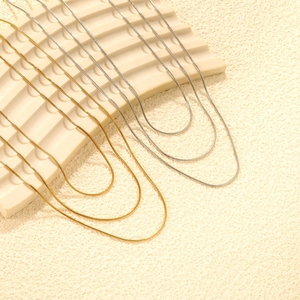 Three-layer stacked round snake chain necklace in polished gold and silver stainless steel