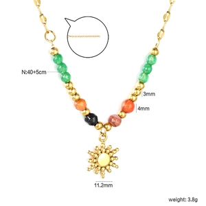 Detail view of a sun pendant necklace with natural stones and dimensions measurement