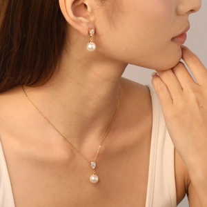 Elegant gold necklace and teardrop zircon pearl earrings jewelry set on model