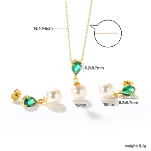 Detailed view of jewelry set with green gemstones, white pearls and size specifications