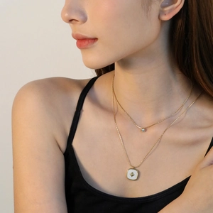 Double-layered 18K gold plated stainless steel necklace with star and shell pendants