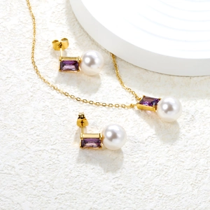 Elegant gold jewelry set featuring purple zircon and pearl heart pendant necklace and earrings