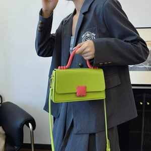 Neon green crossbody handbag with pink wave clasp and top handle for women