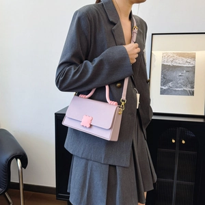 Lavender contrast handbag with pink wave clasp and beaded handle shown on crossbody model