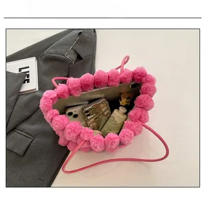 Internal view of pink plush heart tote showing storage space for phone and cosmetics