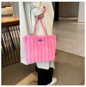 Detail of hot pink plush tote bag with vertical stripes and fashion embroidery