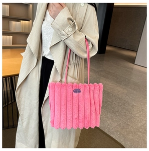 Detailed close-up of pink faux fur tote bag showing plush vertical striped texture