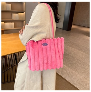 Detail of pink plush tote bag with vertical stripes and fashion cherry patch