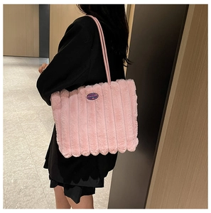 Detail of pink plush tote bag with vertical stripes and Fashion Girl embroidery
