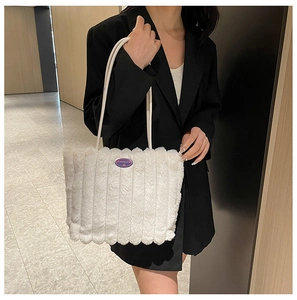 Detailed texture of white plush tote bag with vertical stripes and fashion girl logo