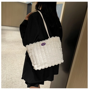 Detail showing plush white tote bag texture with vertical stripes and fashion girl patch