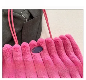 Macro view of pink plush tote bag showing fuzzy vertical stripes and fashion patch detail