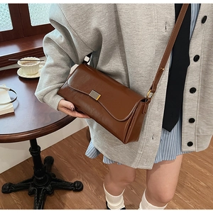Retro brown rectangular faux leather shoulder bag with sleek metal buckle on flap
