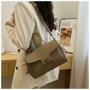 Détail du sac à main en cuir grainé avec fermoir doré et bandoulière réglable