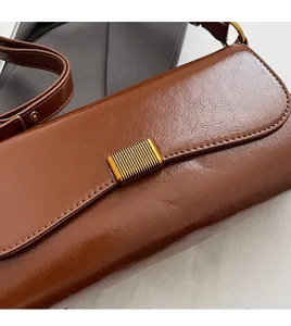 Macro shot of dark brown glossy leather texture with golden rectangle hardware detail