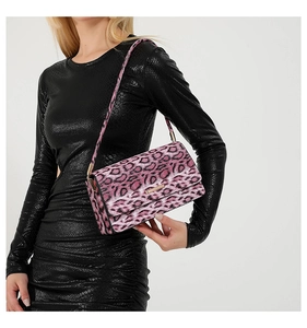 Close-up of pink leopard print shoulder bag with gold hardware and wide strap detail