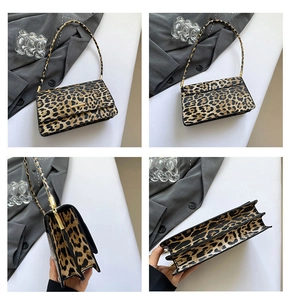 Detail view of leopard print baguette bag with gold hardware and double compartments