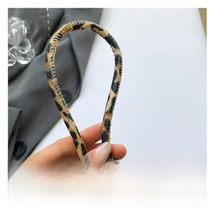 Close-up of slim rounded shoulder strap on leopard print PU leather baguette bag