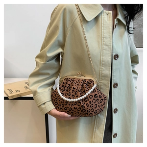 Detail of leopard print pleated shell bag with pearl handle and gold chain strap