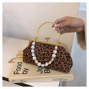 Detail of leopard print bag with gold handle, bead chain and vintage clasp closure