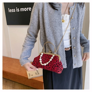 Chic red leopard shell bag with vintage pearl handle and gold chain on model