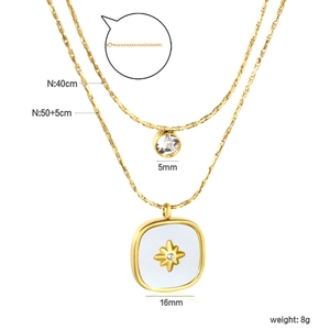 Double-layered gold cylinder white stone necklace featuring a starburst square pendant