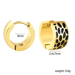 Detail view of 18k gold plated huggie earrings with black enamel spots and 9mm inner diameter