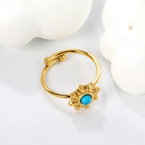 Adjustable sun flower stainless steel ring with turquoise center on white clouds