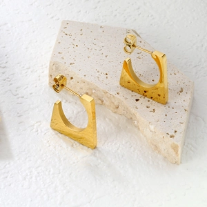 Minimalist rectangular gold-plated stainless steel earrings on a natural stone base