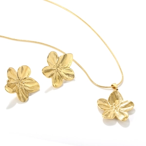 Golden flower jewelry set with textured petal necklace and matching stud earrings