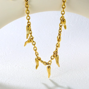 Detailed view of 18k gold plated chain necklace with red chili pepper pendants