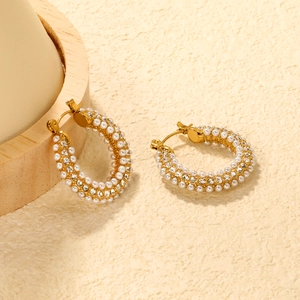 C-shaped gold hoop earrings featuring crystal rhinestones and faux white pearls