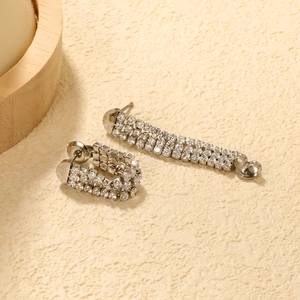 Macro shot of silver-tone C-shape earrings with triple-row cubic zirconia inlay