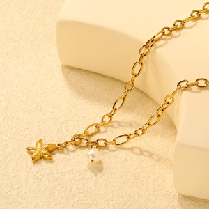 18K gold plated stainless steel starfish necklace with pearl pendant on a stone block