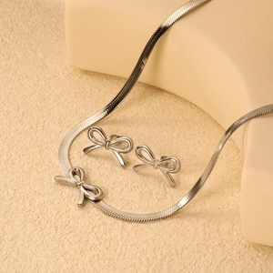 Elegant silver bow jewelry set with snake chain necklace and matching stud earrings