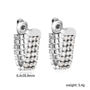 Macro detail of U-shaped drop earrings showing triple-row pave white zircon settings