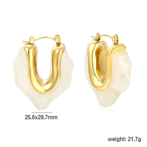 Detail view of U-shaped resin hoop earrings with marble pattern and gold metal accent