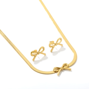 Polished gold bow jewelry set with flat snake chain necklace and matching stud earrings